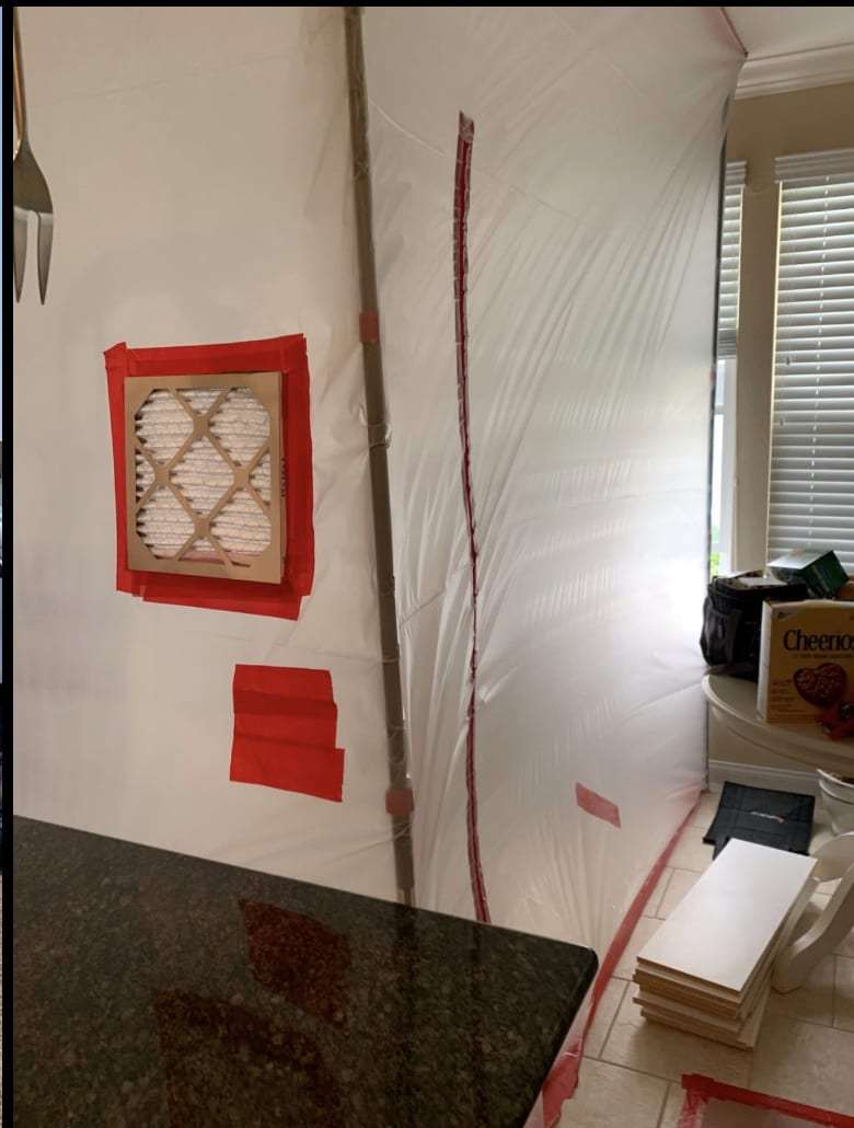Plastic containment wall with a filter port for negative air