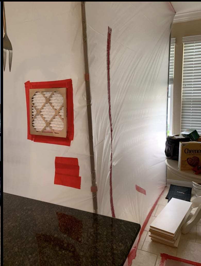 Plastic containment wall with a filter port for negative air